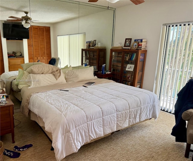 carpeted bedroom with a ceiling fan and access to outside