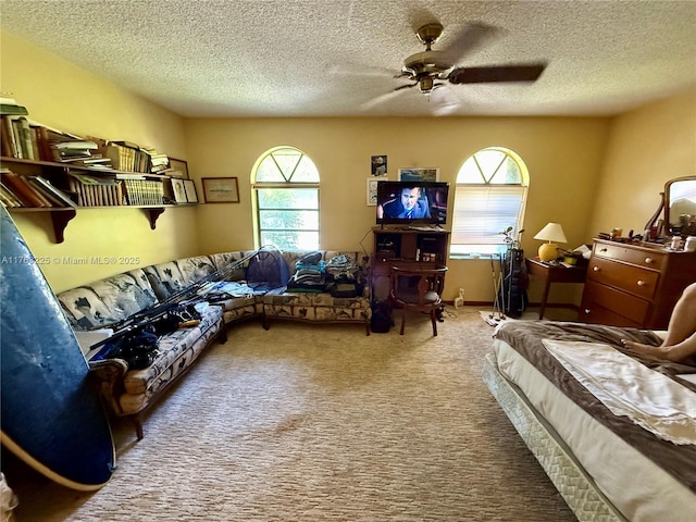 interior space featuring a ceiling fan and a textured ceiling