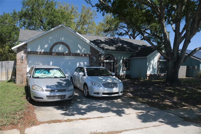 ranch-style house with fence, a garage, driveway, and roof with shingles