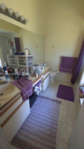 bathroom with tile patterned flooring, toilet, and vanity