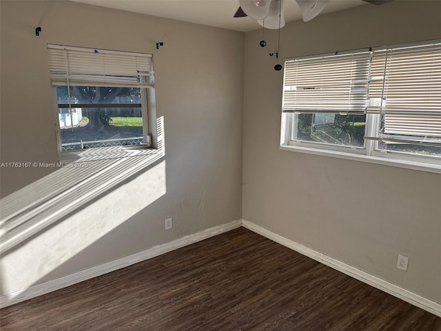 empty room featuring a ceiling fan, baseboards, and wood finished floors