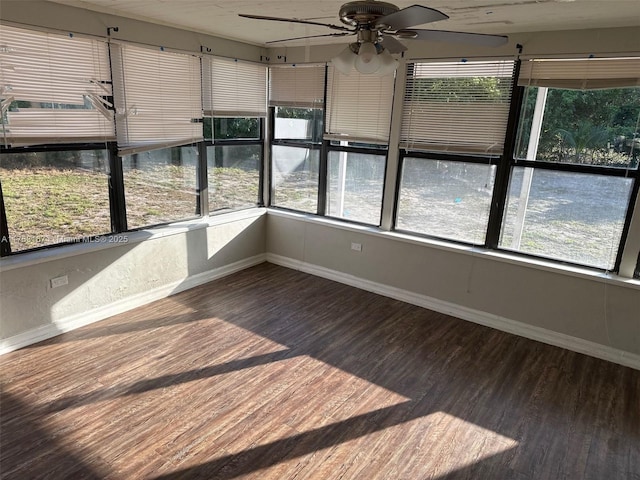 unfurnished sunroom with a ceiling fan