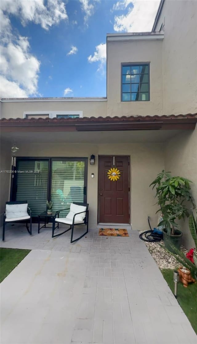 property entrance with stucco siding