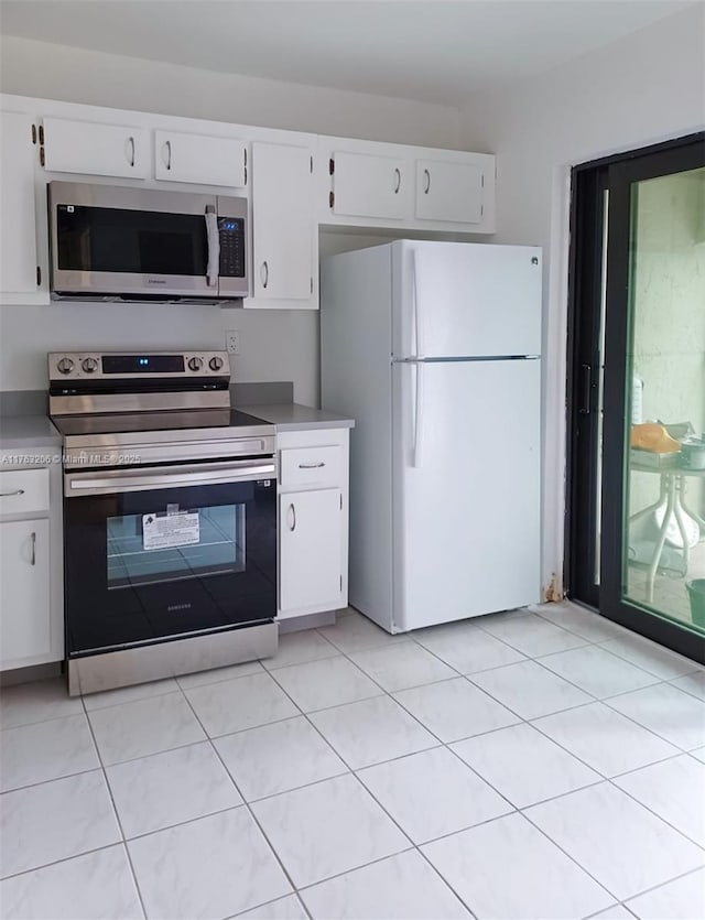 kitchen featuring appliances with stainless steel finishes, light countertops, and white cabinetry