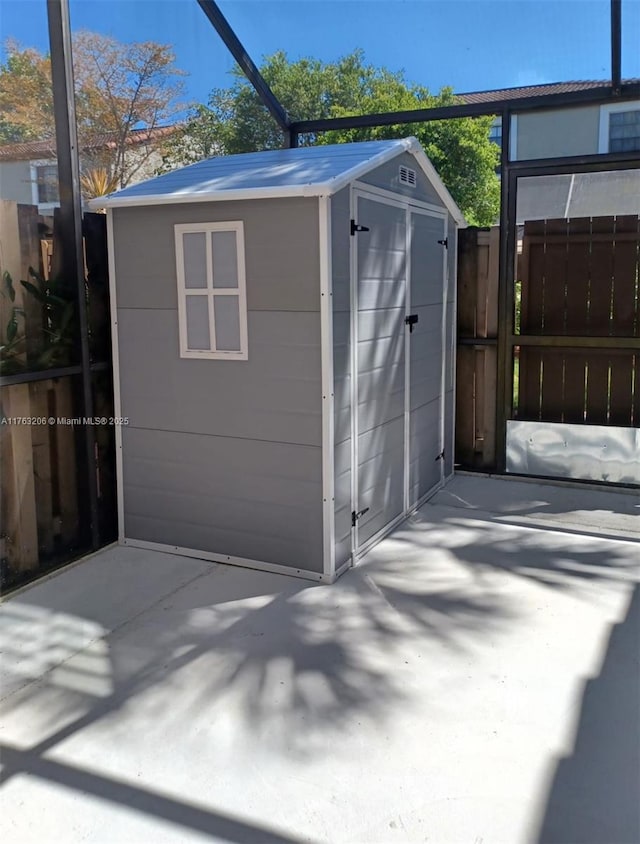 view of shed featuring fence