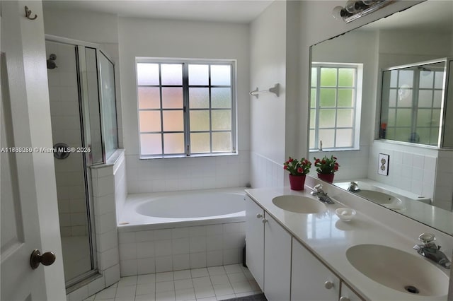 bathroom featuring a stall shower and a sink