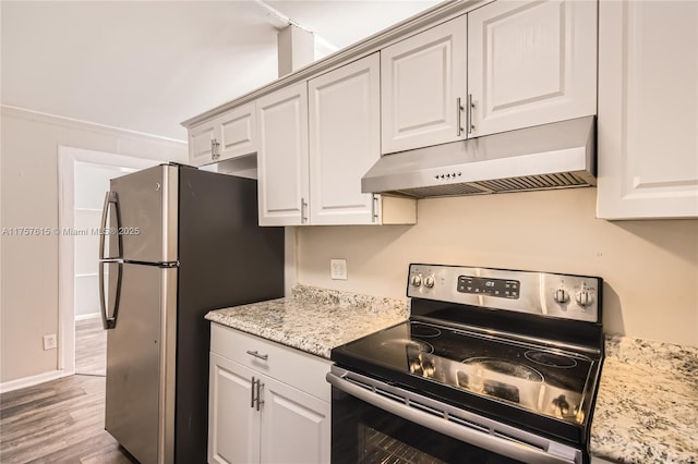 kitchen with under cabinet range hood, light stone counters, wood finished floors, appliances with stainless steel finishes, and white cabinets