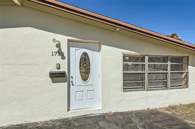 property entrance featuring stucco siding