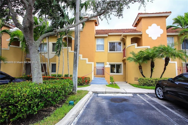 view of building exterior featuring uncovered parking