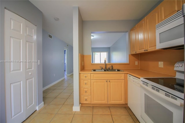 kitchen with a sink, visible vents, white appliances, and light tile patterned floors