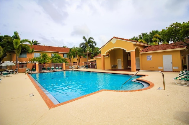 pool featuring a patio and fence