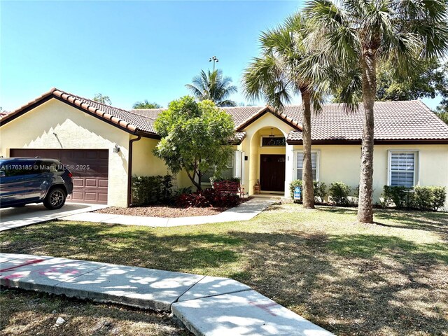 19922 NW 88th Ave, Hialeah, FL 33018 - mediterranean / spanish-style house featuring stucco siding, a tiled roof, a garage, and a front lawn