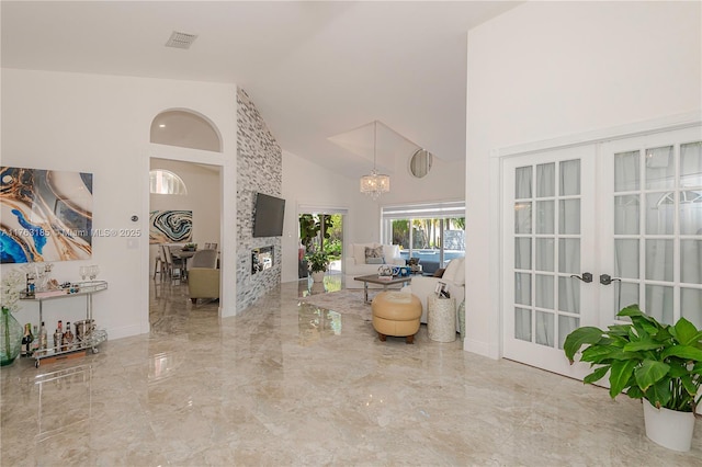 interior space with visible vents, a chandelier, french doors, marble finish floor, and high vaulted ceiling