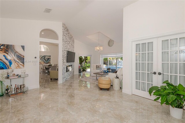 19922 NW 88th Ave, Hialeah, FL 33018 - entrance foyer with french doors, high vaulted ceiling, marble tiled flooring, and a chandelier