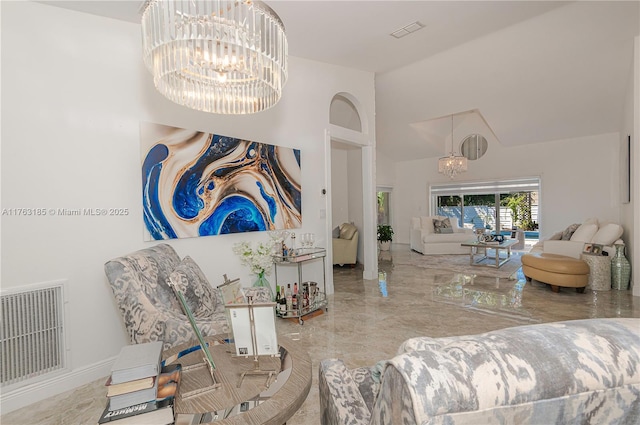 living area with a chandelier, visible vents, marble finish floor, and high vaulted ceiling