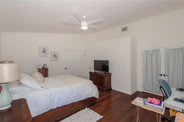 bedroom with visible vents, a ceiling fan, wood finished floors, baseboards, and lofted ceiling