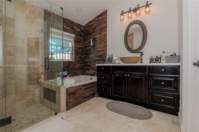 bathroom featuring vanity, vaulted ceiling, a bath, and a stall shower