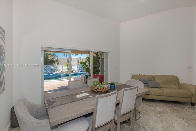 dining area featuring a high ceiling