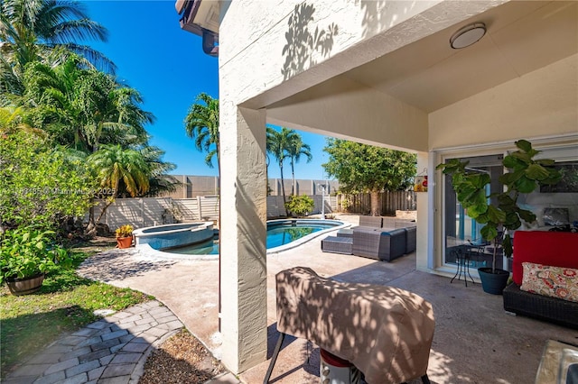 view of patio with a fenced backyard, outdoor lounge area, and a pool with connected hot tub