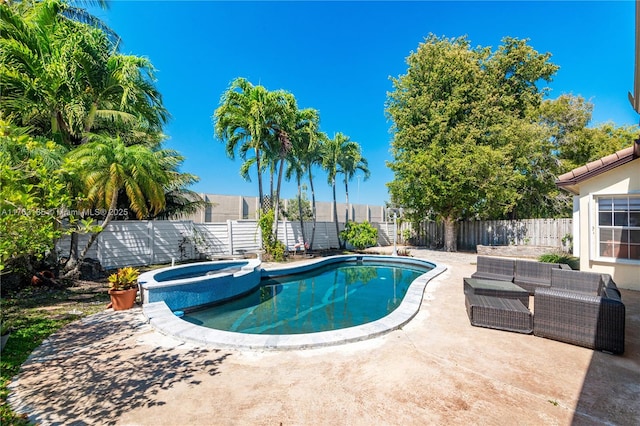 view of pool featuring a patio area, an outdoor living space, a pool with connected hot tub, and a fenced backyard