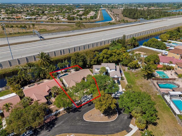 19922 NW 88th Ave, Hialeah, FL 33018 - aerial perspective of suburban area featuring property boundaries highlighted, a nearby body of water, and a pool area