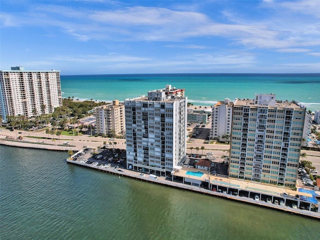 birds eye view of property featuring a view of city and a water view