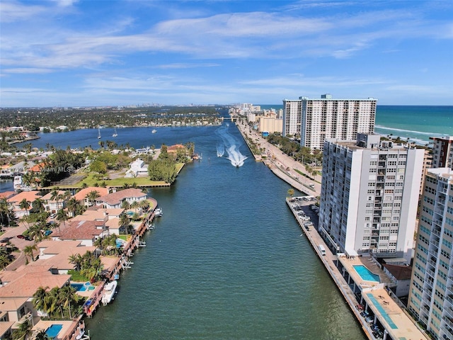 birds eye view of property featuring a water view and a view of city