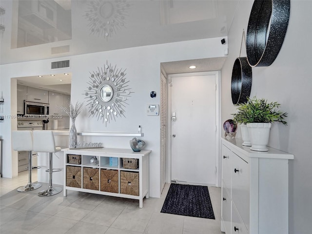 entryway featuring light tile patterned floors and visible vents