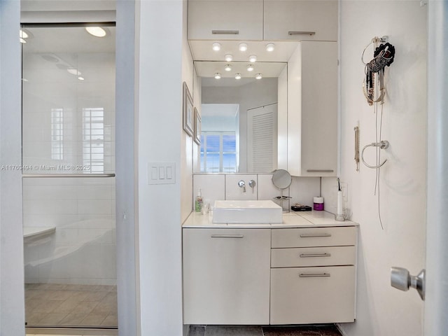 bathroom with vanity and a shower stall