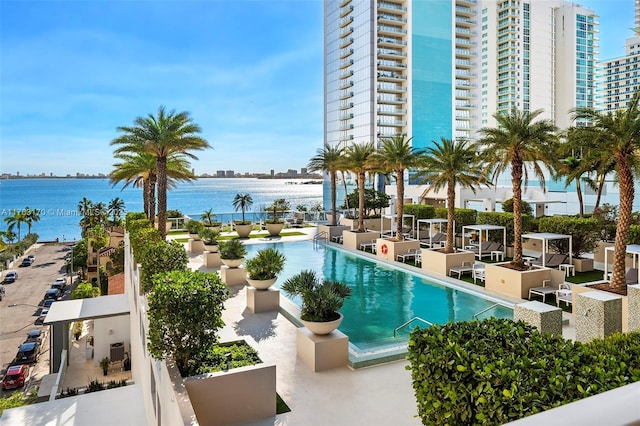 view of swimming pool with a water view