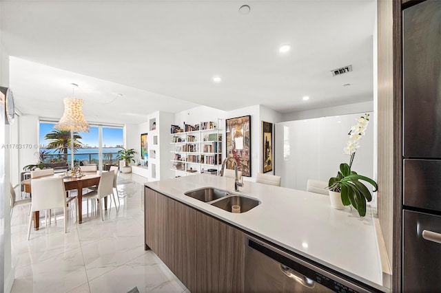 kitchen with visible vents, marble finish floor, modern cabinets, a sink, and open floor plan