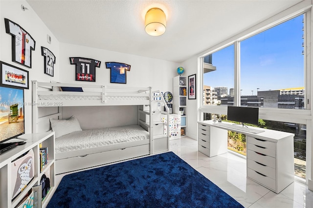 bedroom with a wall of windows and marble finish floor