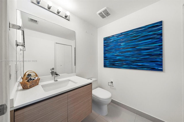 bathroom with visible vents, toilet, vanity, and tile patterned flooring