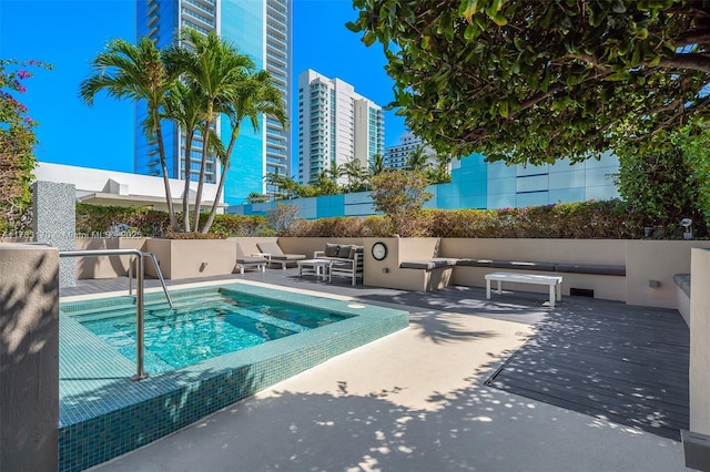 view of pool featuring a patio area, outdoor lounge area, and fence