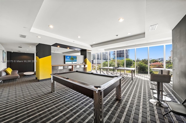 recreation room with visible vents, recessed lighting, a tray ceiling, and carpet floors