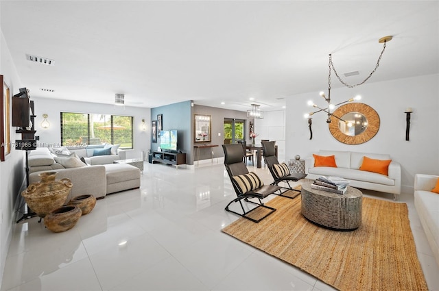 living area with tile patterned floors, visible vents, and baseboards