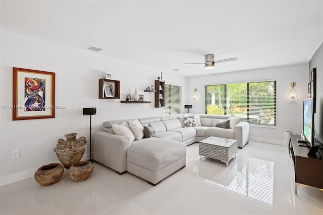 living area with ceiling fan, visible vents, baseboards, and light tile patterned flooring