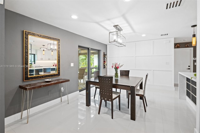 dining area featuring a decorative wall, light tile patterned flooring, recessed lighting, and visible vents