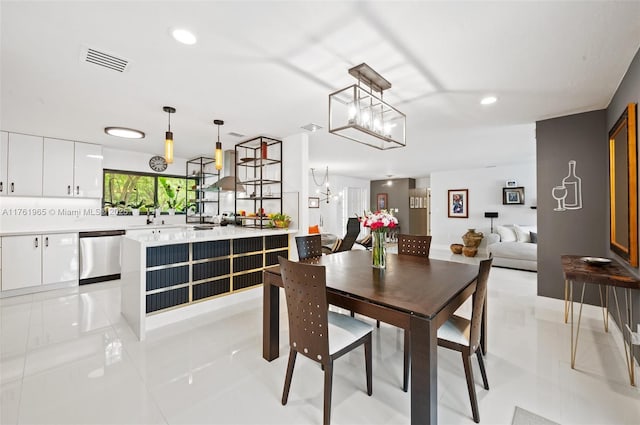 dining space with light tile patterned floors, visible vents, recessed lighting, and a chandelier