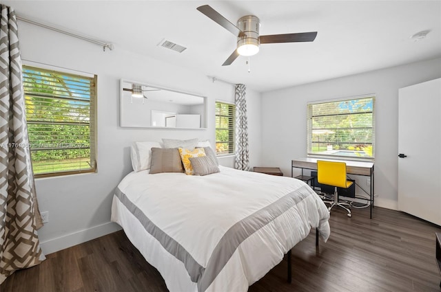 bedroom with visible vents, baseboards, wood finished floors, and a ceiling fan