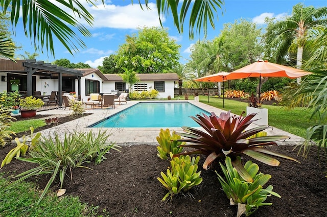 view of pool with a fenced in pool, fence, a lawn, a pergola, and a patio