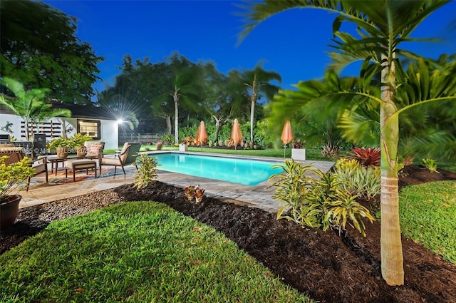 view of swimming pool with a fenced in pool, a patio, and fence