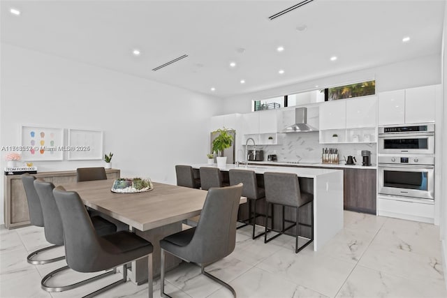 dining room featuring visible vents, recessed lighting, and marble finish floor