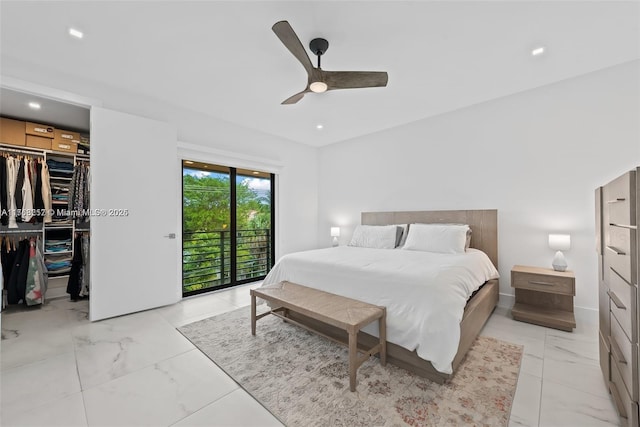 bedroom featuring a spacious closet, access to exterior, a closet, marble finish floor, and a ceiling fan