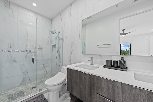 full bathroom featuring a marble finish shower, tile walls, toilet, marble finish floor, and vanity