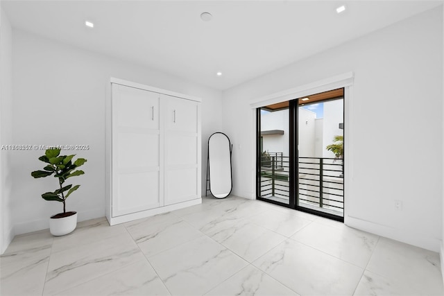 empty room with recessed lighting and marble finish floor