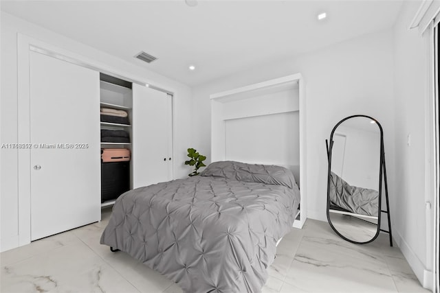 bedroom with a closet, visible vents, marble finish floor, and recessed lighting