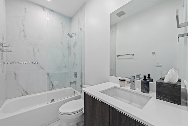 bathroom with visible vents, vanity, toilet, and  shower combination