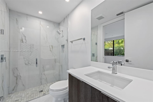 bathroom featuring a marble finish shower, visible vents, toilet, and vanity