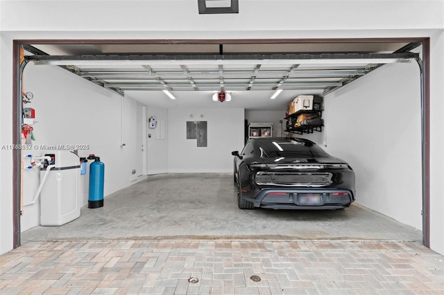 garage featuring electric panel and a garage door opener